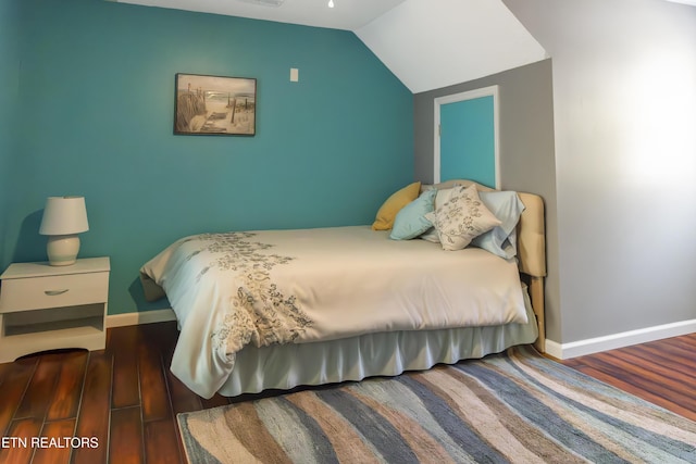 bedroom featuring dark hardwood / wood-style floors and vaulted ceiling