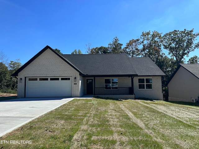 view of front of property featuring a front yard and a garage