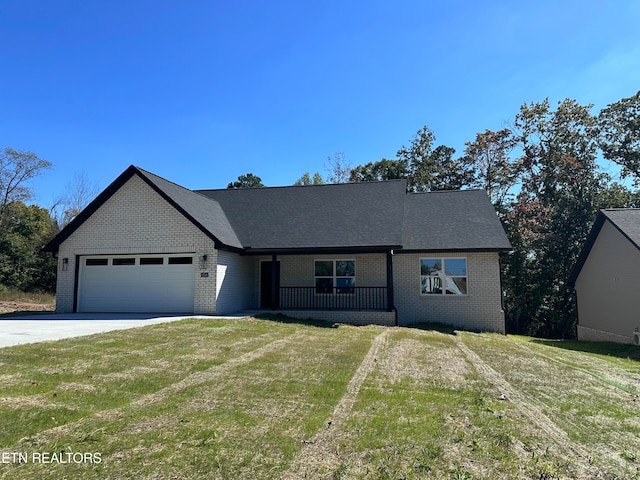 view of front of house with a front yard and a garage