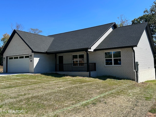 view of front of home with a front yard and a garage