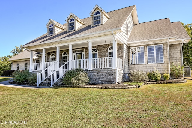 new england style home with a front yard and a porch