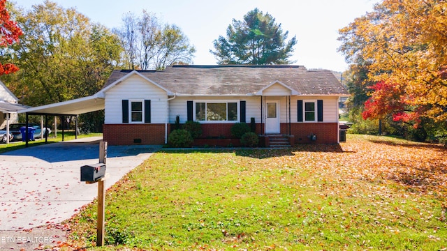 ranch-style home featuring a front yard and a carport