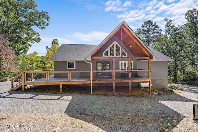 rear view of house featuring a wooden deck