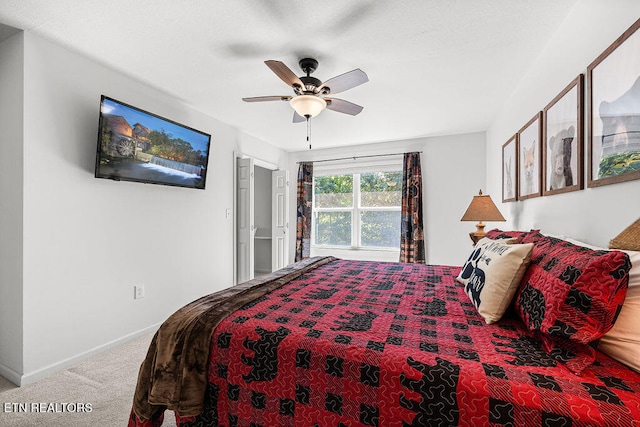 bedroom featuring ceiling fan and carpet