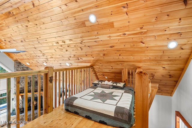 bedroom with wood-type flooring, vaulted ceiling, and wooden ceiling