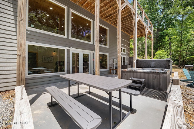 view of patio with french doors and a hot tub