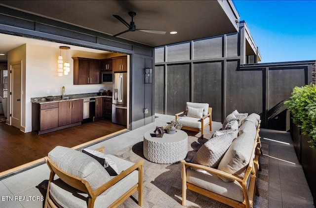 view of patio featuring ceiling fan and an outdoor living space