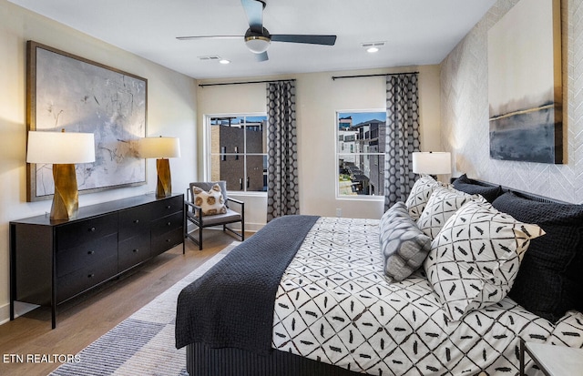 bedroom with hardwood / wood-style flooring and ceiling fan