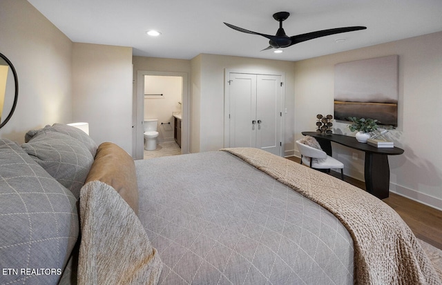 bedroom with hardwood / wood-style flooring, ceiling fan, a closet, and ensuite bathroom