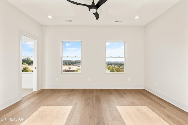 spare room featuring light wood-type flooring and ceiling fan