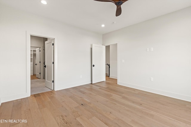 unfurnished bedroom with light wood-type flooring and ceiling fan