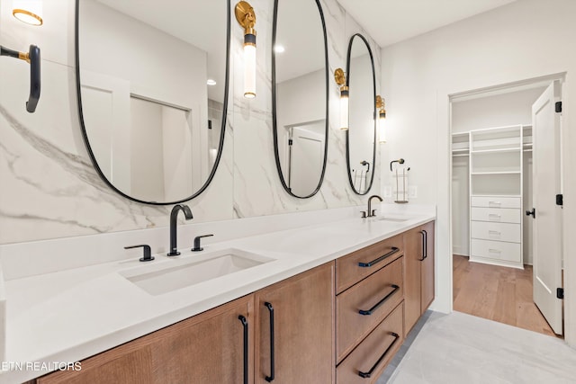 bathroom with walk in shower, vanity, and hardwood / wood-style flooring