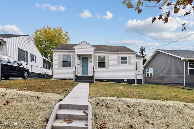 bungalow-style home with a front yard