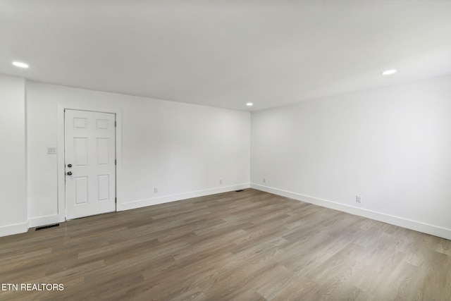 unfurnished room with wood-type flooring