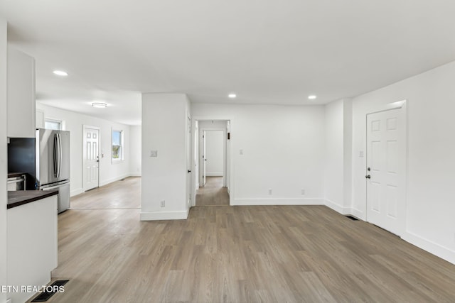 unfurnished living room featuring light hardwood / wood-style floors