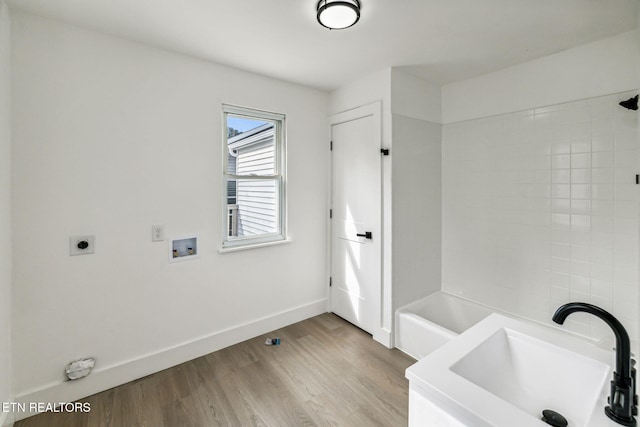 bathroom with hardwood / wood-style flooring and sink