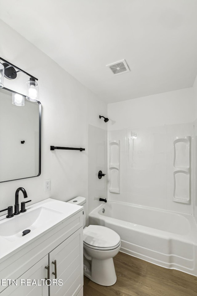 full bathroom featuring toilet, shower / tub combination, vanity, and wood-type flooring