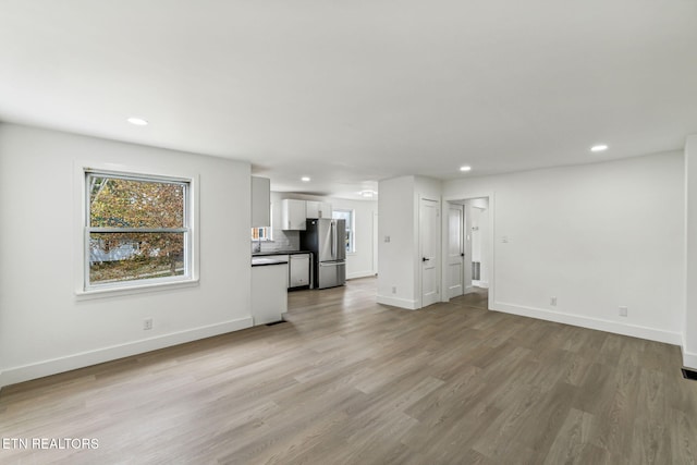 unfurnished living room with light hardwood / wood-style floors