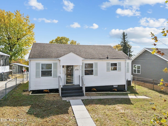 bungalow-style home with a front lawn