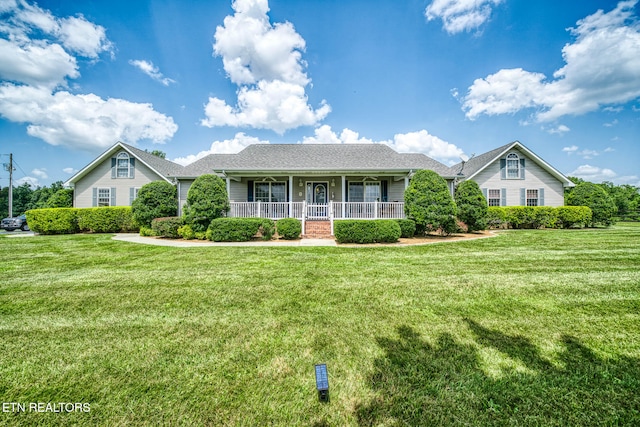 ranch-style home with a porch and a front yard