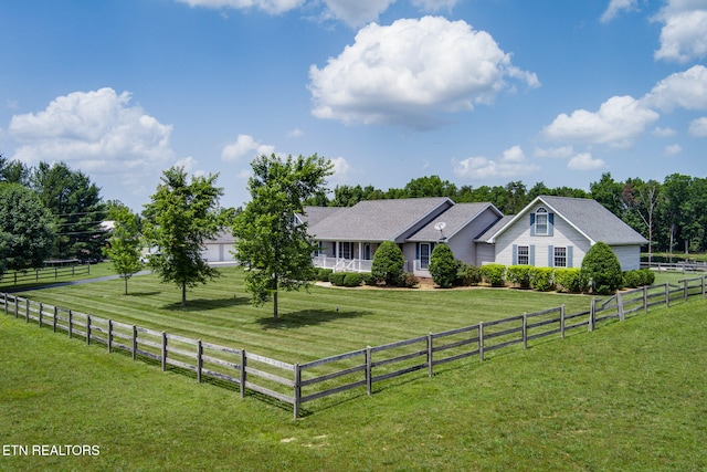 view of front of property featuring a front lawn and a rural view