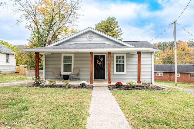 bungalow-style house featuring a porch and a front yard