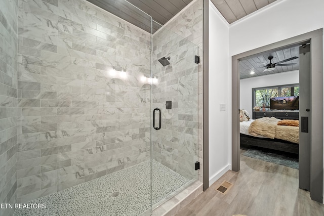 bathroom featuring wood ceiling, a shower with door, hardwood / wood-style flooring, ornamental molding, and ceiling fan