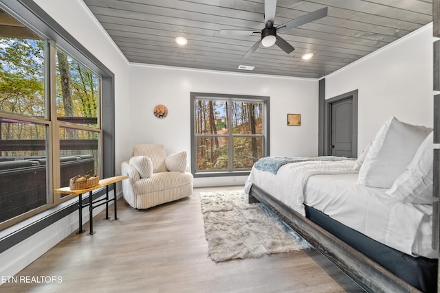 bedroom with ornamental molding, light hardwood / wood-style flooring, ceiling fan, and wood ceiling