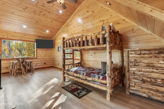 bedroom featuring wooden ceiling, ceiling fan, high vaulted ceiling, hardwood / wood-style floors, and wooden walls