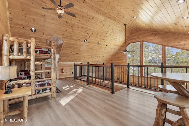 bedroom with high vaulted ceiling, wood walls, hardwood / wood-style flooring, and wood ceiling