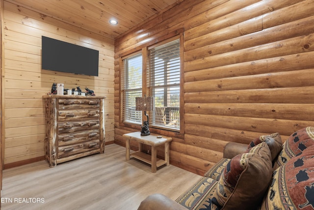 sitting room with rustic walls, light hardwood / wood-style flooring, and wood ceiling