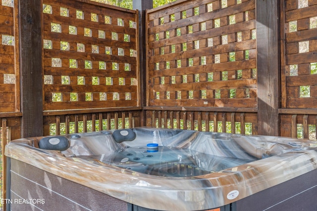 wooden deck featuring a hot tub