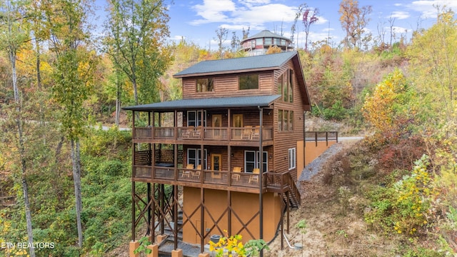 rear view of house featuring a balcony