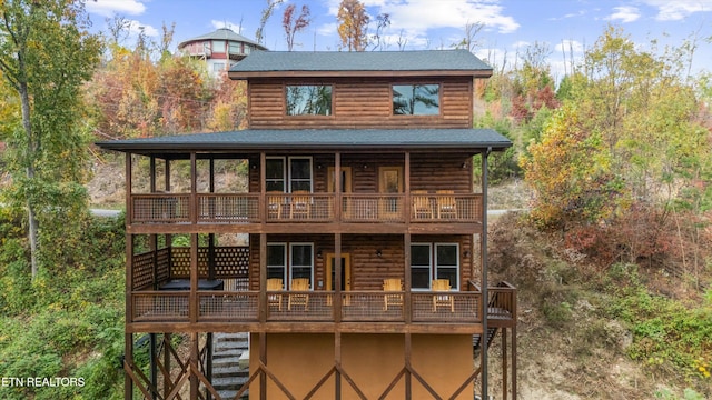 rear view of property featuring a wooden deck