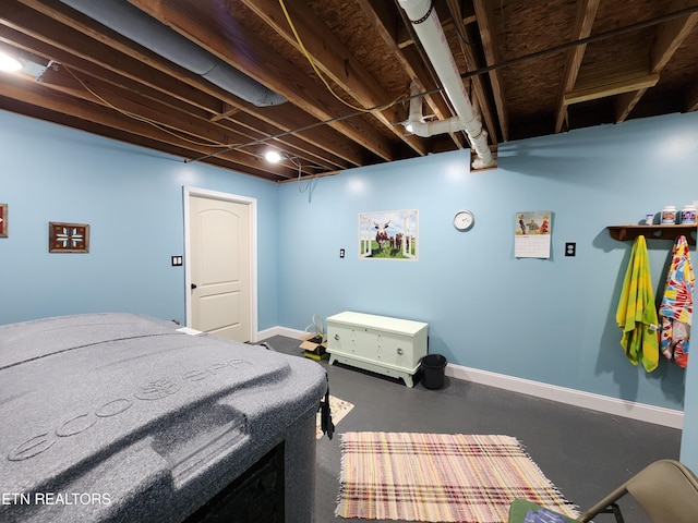 bedroom featuring concrete flooring