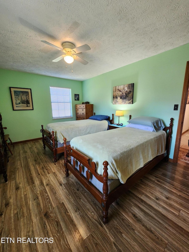 bedroom with dark wood-type flooring, ceiling fan, and a textured ceiling