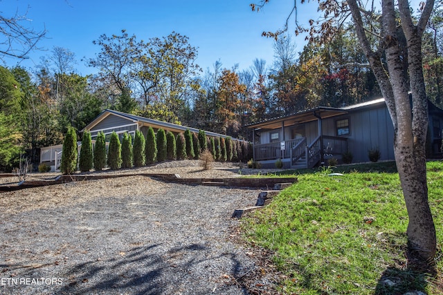 view of yard with covered porch