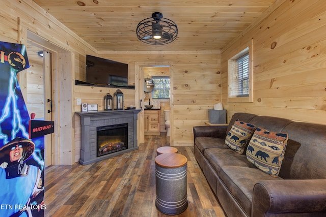 living room with wood walls, ceiling fan, wooden ceiling, and dark hardwood / wood-style floors