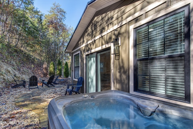 exterior space with a hot tub