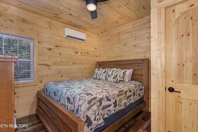 bedroom featuring ceiling fan, wood walls, dark hardwood / wood-style floors, and a wall unit AC