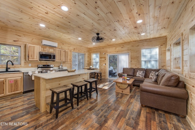 living room featuring ceiling fan, sink, dark wood-type flooring, wooden ceiling, and wooden walls