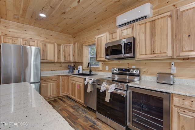 kitchen featuring a wall mounted air conditioner, light stone countertops, stainless steel appliances, beverage cooler, and sink