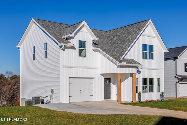 modern farmhouse with central AC, a front lawn, and a garage