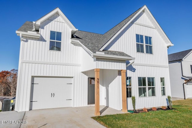 modern farmhouse style home featuring a front yard and a garage