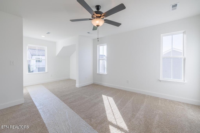 carpeted empty room featuring ceiling fan