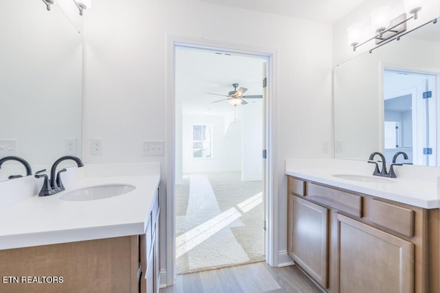 bathroom featuring hardwood / wood-style floors, ceiling fan, and vanity