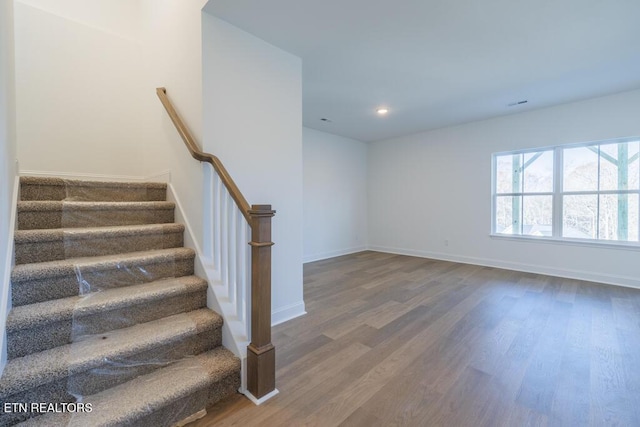 stairs featuring hardwood / wood-style flooring