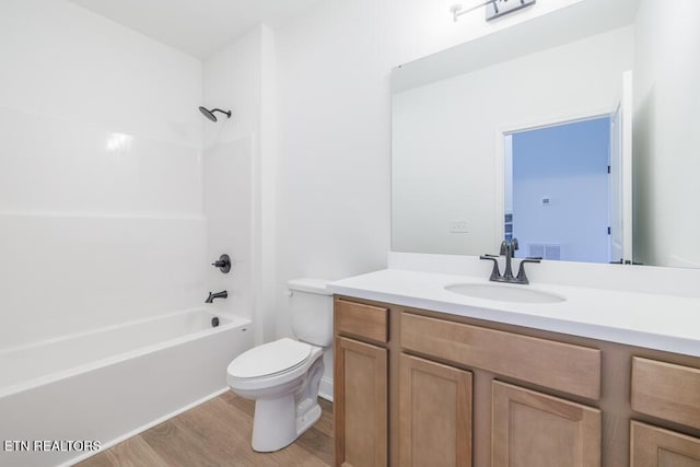 full bathroom featuring shower / bathing tub combination, vanity, toilet, and hardwood / wood-style flooring