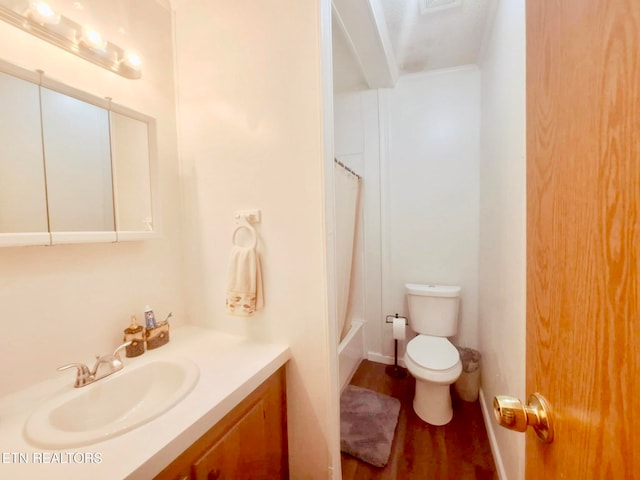 bathroom with hardwood / wood-style floors, vanity, and toilet