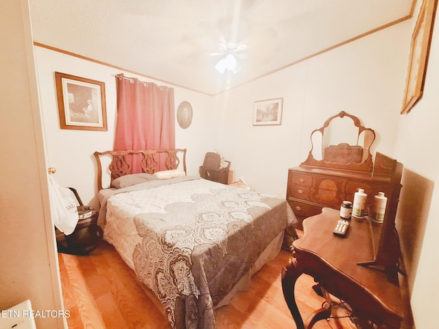 bedroom with ceiling fan and light hardwood / wood-style floors